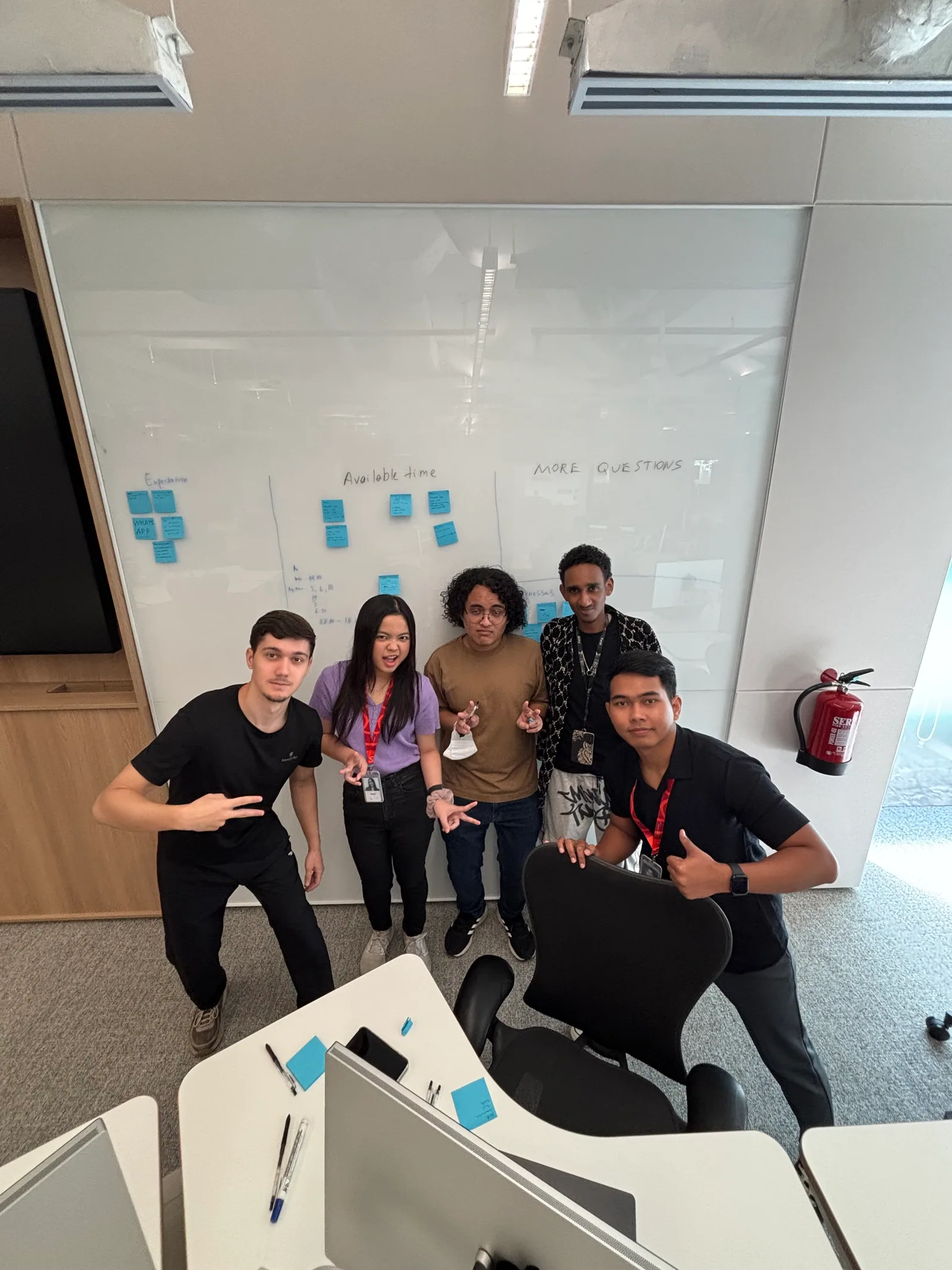 The BomBocLat team posing in front of a whiteboard at the Apple Developer Academy