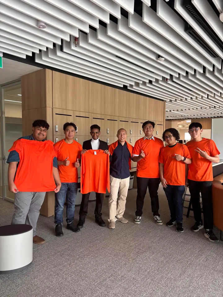 A group of Academy learners in matching orange shirts