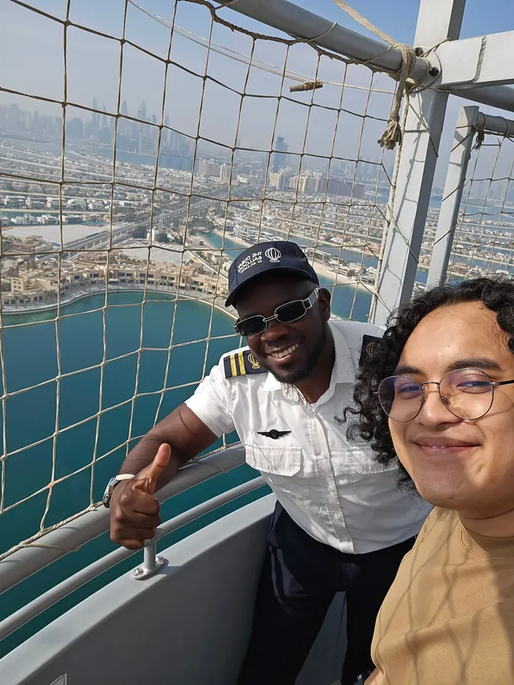 Selfie with a smiling crew member on a balcony high above the Palm Jumeirah
