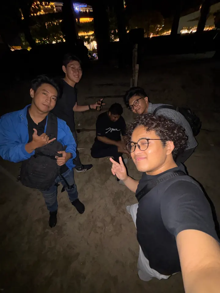 Night-time selfie of the team outdoors