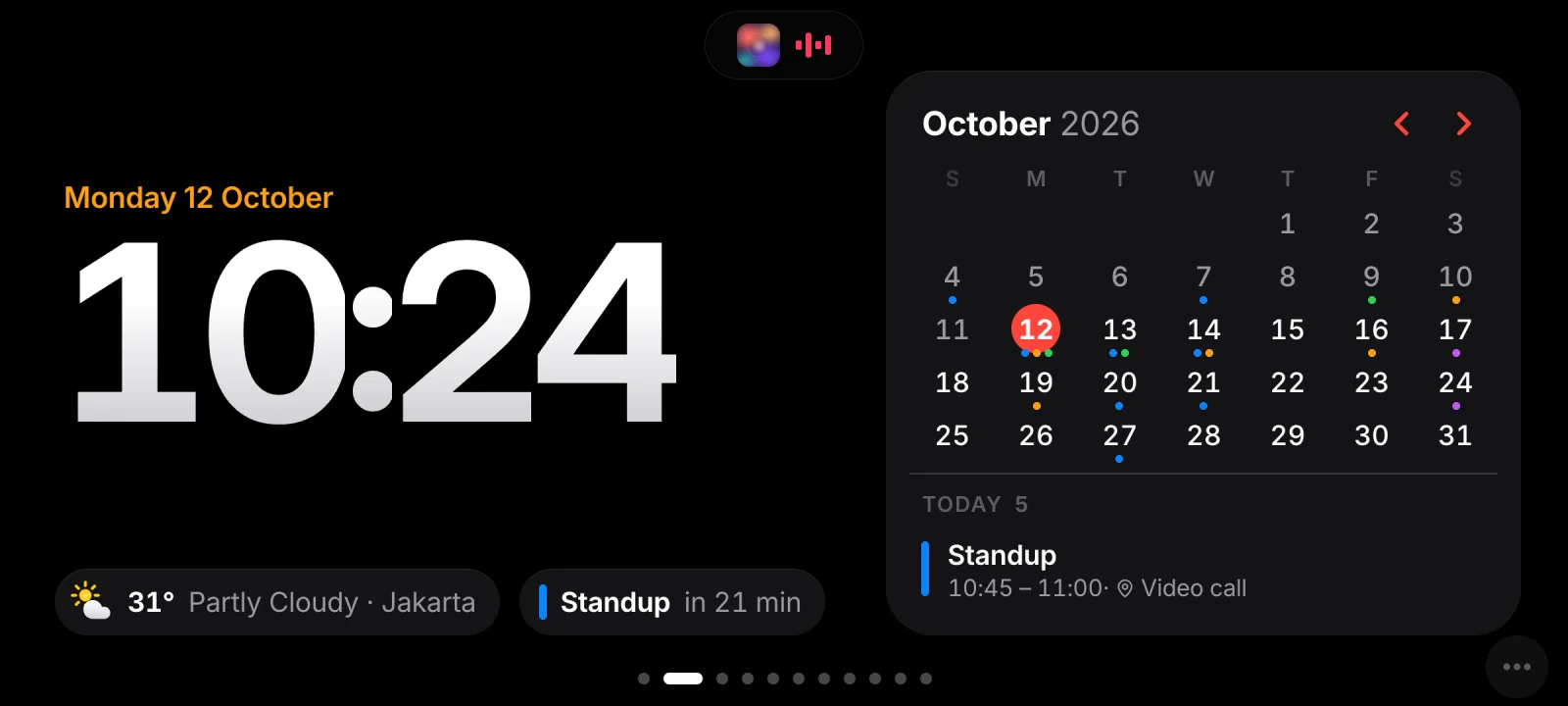 Clock: a large 10:24 with the date, the weather and the next meeting, beside a month calendar with today’s agenda