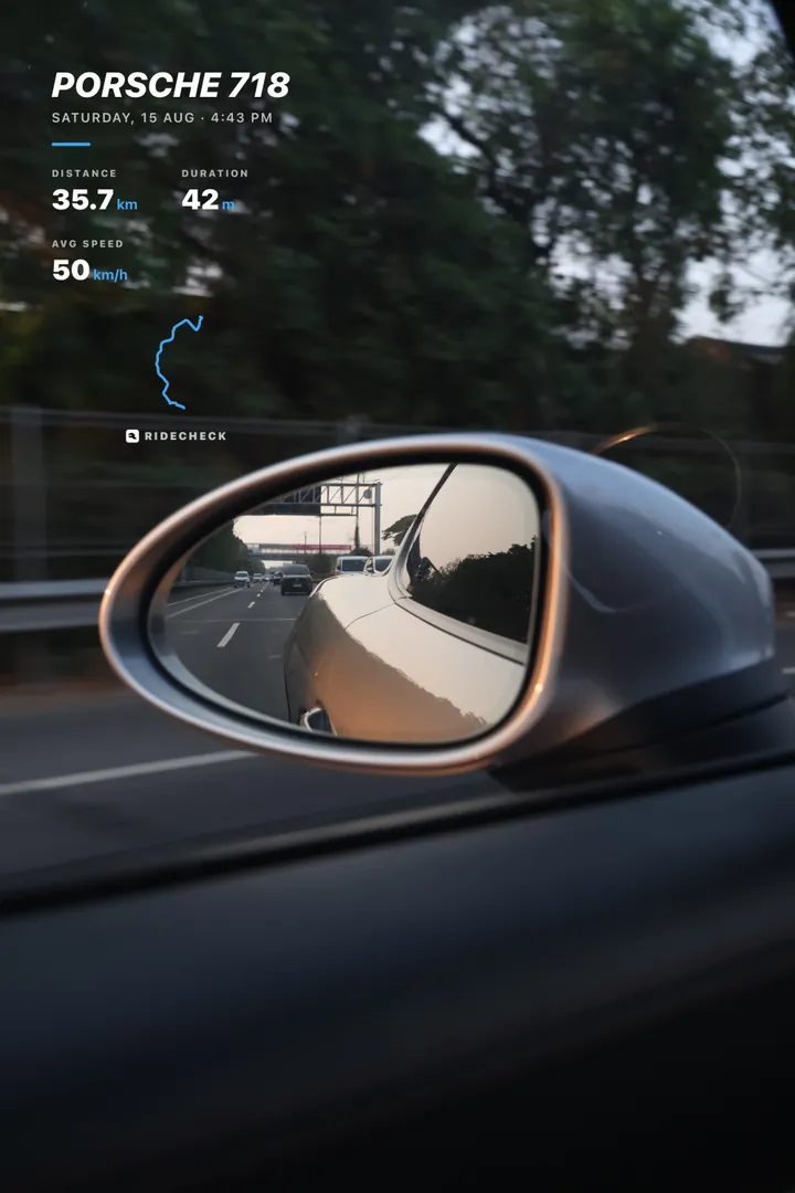A trip card over a wing-mirror photo
